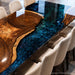 Solid walnut epoxy resin table with a high-gloss finish that enhances the depth of the wood texture and blue resin details.