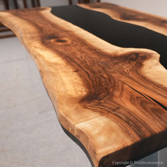Black walnut resin river table used as an elegant dining room centerpiece
