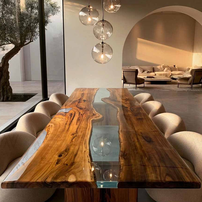 Handcrafted clear epoxy dining table made with a solid walnut slab and unique natural details.