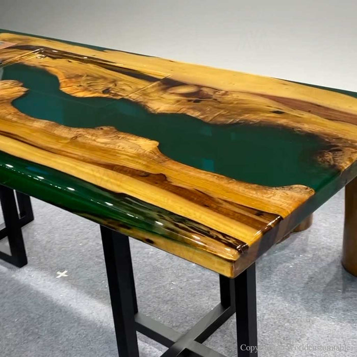 Custom green epoxy resin table combining natural wood beauty with modern artistic resin design.