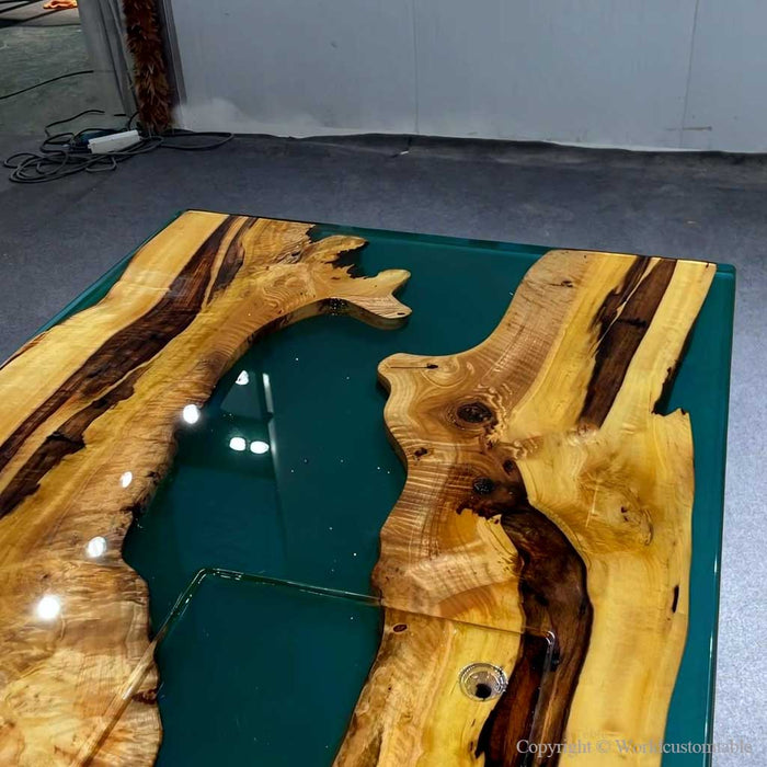 Custom green epoxy resin table combining natural wood beauty with modern artistic resin design.