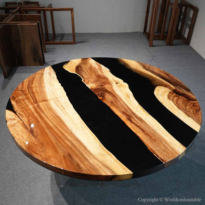 Modern live edge epoxy dining table featuring walnut wood and deep black resin