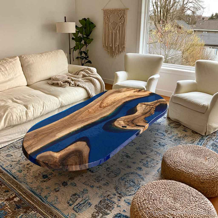 Boat shaped black walnut coffee table with blue epoxy river