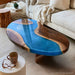 Blue walnut resin coffee table with an organic pea shaped silhouette