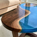 Handmade walnut epoxy coffee table with flowing blue resin