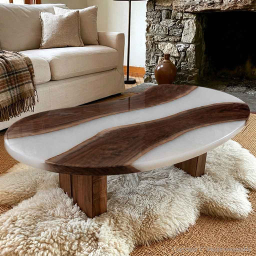 Black walnut epoxy coffee table with a distinctive pea shaped silhouette and white resin