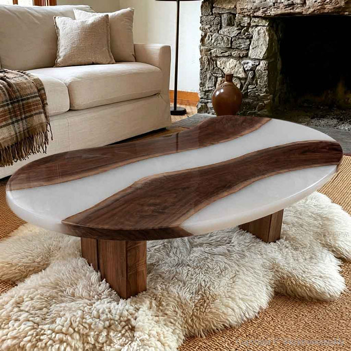 Black walnut epoxy coffee table with a distinctive pea shaped silhouette and white resin