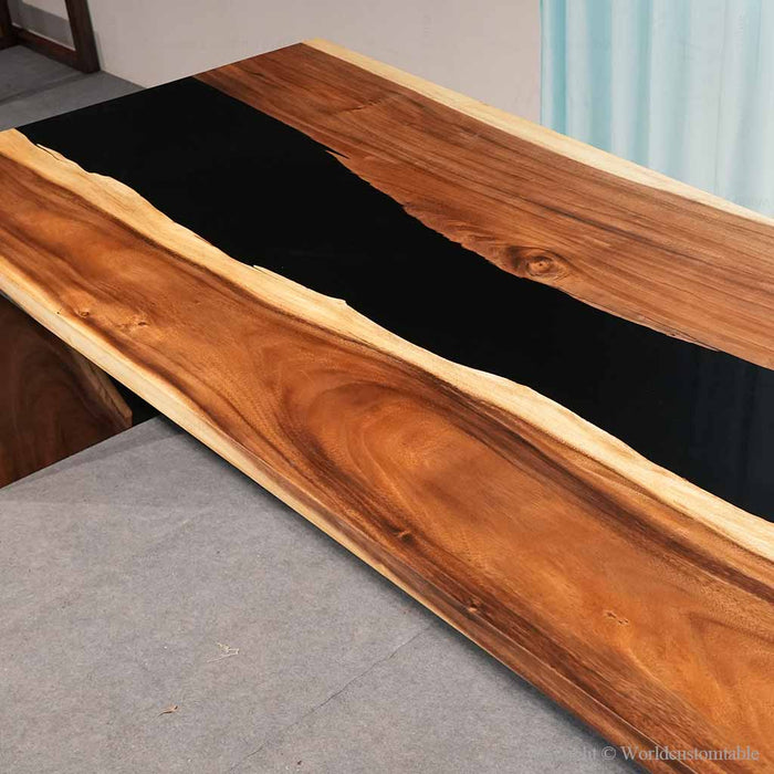 Live edge walnut resin desk with dramatic black epoxy
