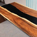 Live edge walnut resin desk with dramatic black epoxy