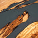 Olive dining table featuring translucent smoky gray resin