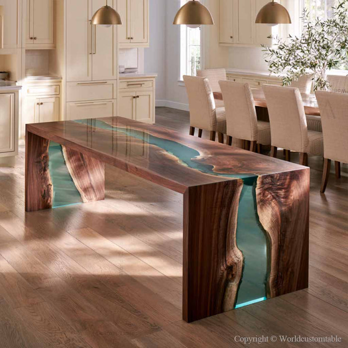 Transparent teal epoxy resin flowing between black walnut slabs with rich natural wood grain