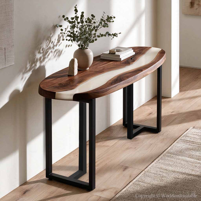 Black walnut epoxy console table with white resin positioned behind a sofa in a contemporary living room