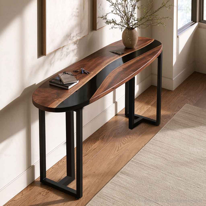Close up of black epoxy resin alongside distinctive black walnut grain on a handcrafted console table