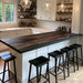 Black walnut epoxy island top with black resin used as a contemporary home bar countertop