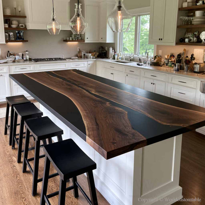 Custom black walnut epoxy island countertop with a dramatic black resin river in a luxury open concept kitchen