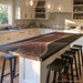 Modern kitchen featuring a black walnut epoxy island top with black resin and pendant lights