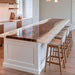 Black walnut epoxy island top with a pearl white resin river in a modern kitchen