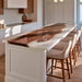 Luxury open concept kitchen featuring a custom black walnut island top with pearl white epoxy resin