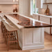 Modern kitchen with a black walnut epoxy island top featuring pearl white resin and pendant lighting