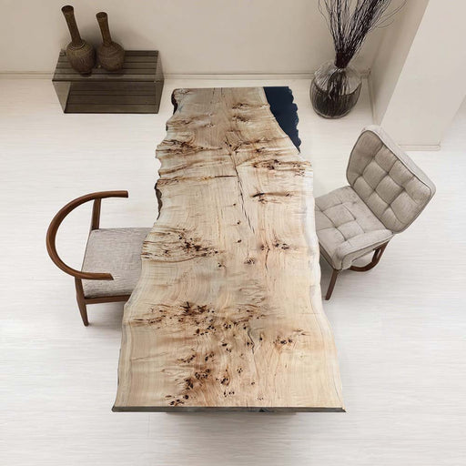 Wooden dining table with natural grain pattern in a minimalistic room.