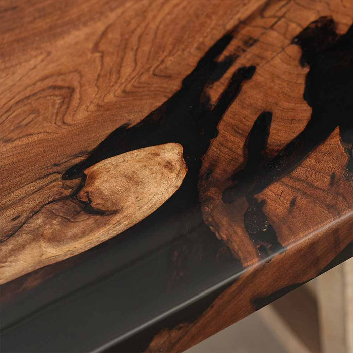 Close-up of a wooden surface with black resin inlay