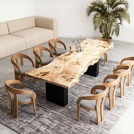 Dining area with a long wooden table and chairs in a modern interior setting.