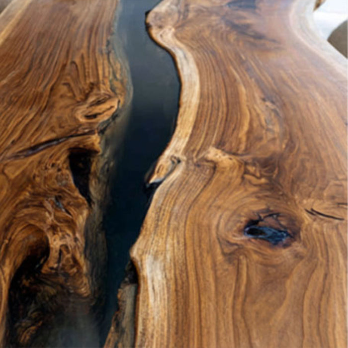 Large dining table made of solid walnut wood and black epoxy resin.