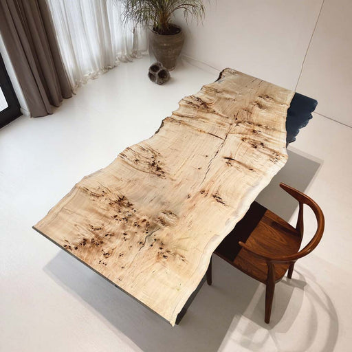 Wooden desk with a natural finish in a minimalistic room.