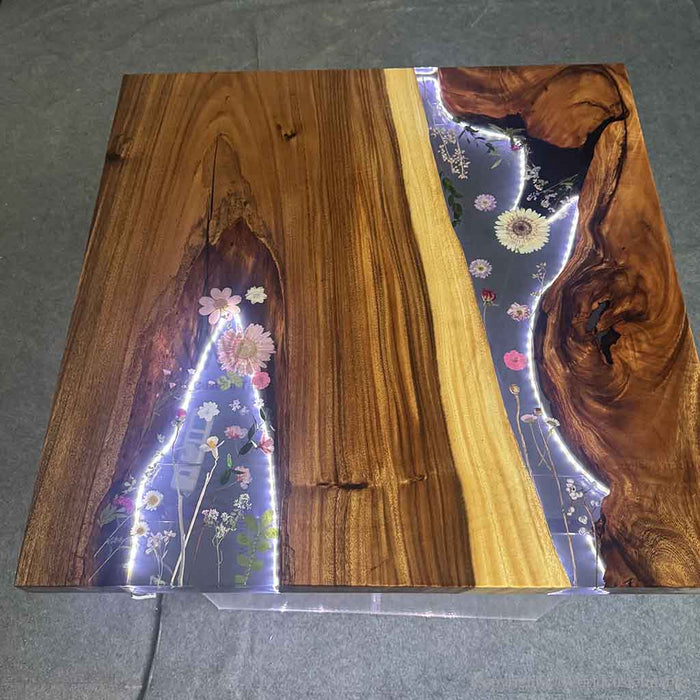 Modern LED epoxy coffee table placed in cozy lounge space with ambient lighting effect