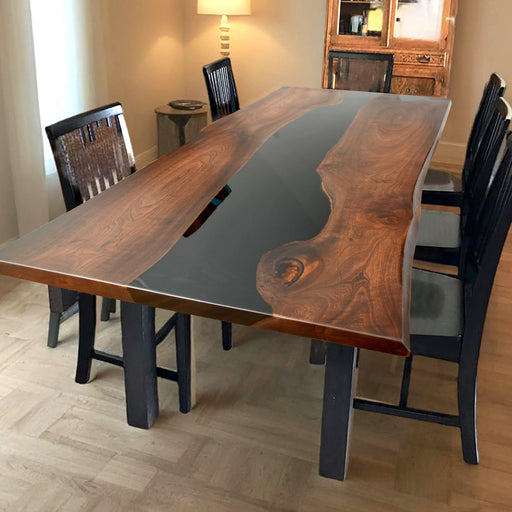 A sleek epoxy resin wood dining table with a dark wood grain and a flowing black epoxy resin river 