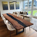Dining room with a wooden table and chairs, featuring abstract wall art.