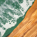 Detailed view of the live edge craftsmanship and smooth epoxy resin finish.