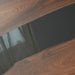 A handcrafted modern epoxy resin wood table with a dark wood grain and a flowing black epoxy resin river 