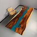 Wooden table with blue resin inlay next to a chair in a minimalistic room.