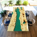 Live edge wood dining table with flowing green epoxy resin design.
