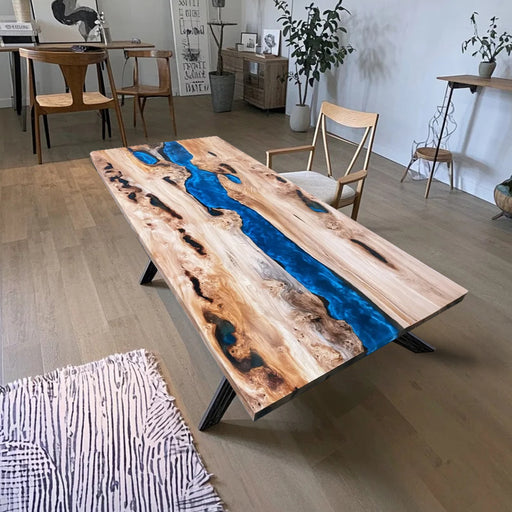 Modern live-edge olive wood table featuring a vivid blue resin river design