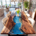 Live edge epoxy river table with blue stone river detail