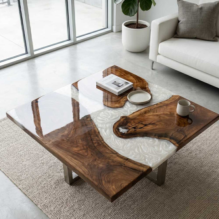 Luxury live edge resin table styled in a minimalist white living room with a neutral rug.