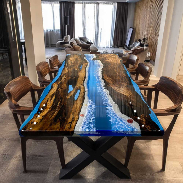Live-edge golden camphor table featuring deep ocean-blue epoxy resin.