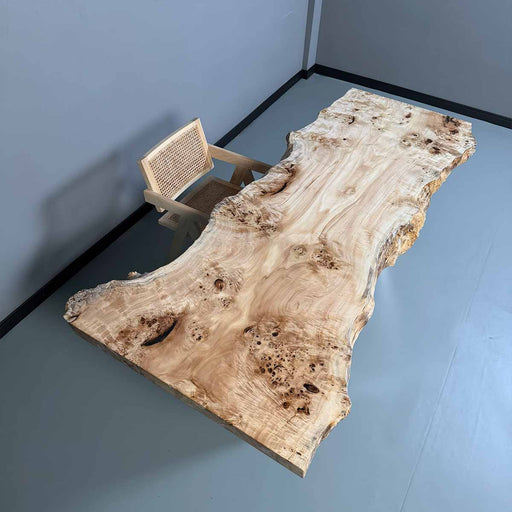 Wooden dining table with a natural, rustic finish in a minimalistic room.