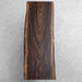 Live edge dining table made from a single century-old South American rain tree slab, organic and bold.