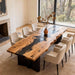 Dining room with a large wooden table and chairs near a window.