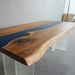 Luxury live edge walnut conference table with translucent blue epoxy river.