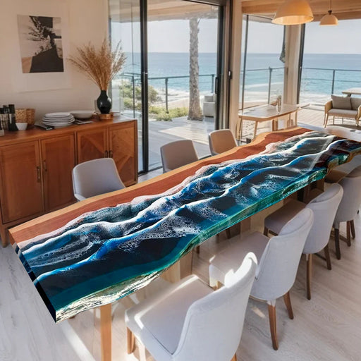 Dining room with a unique blue glass table featuring wave design, large windows overlooking the ocean.
