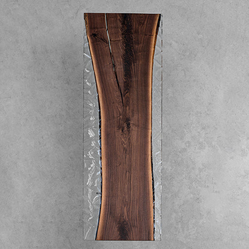 Live edge black walnut epoxy table with transparent resin sides, luxury handcrafted modern furniture.