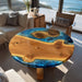 Wooden table with blue resin finish in a living room with ocean view