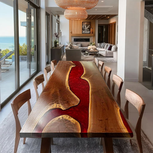 Dining room with a unique wooden table featuring a red and gold design, surrounded by chairs.