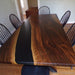 Live edge walnut dining table featuring a sleek black epoxy resin, made in the USA.
