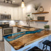 Luxury epoxy kitchen island countertop featuring walnut wood and natural stone inlay accents