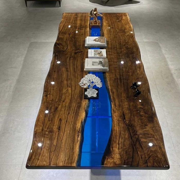Close up of the rich chocolate wood grain and organic edges of premium American black walnut joined by blue resin.